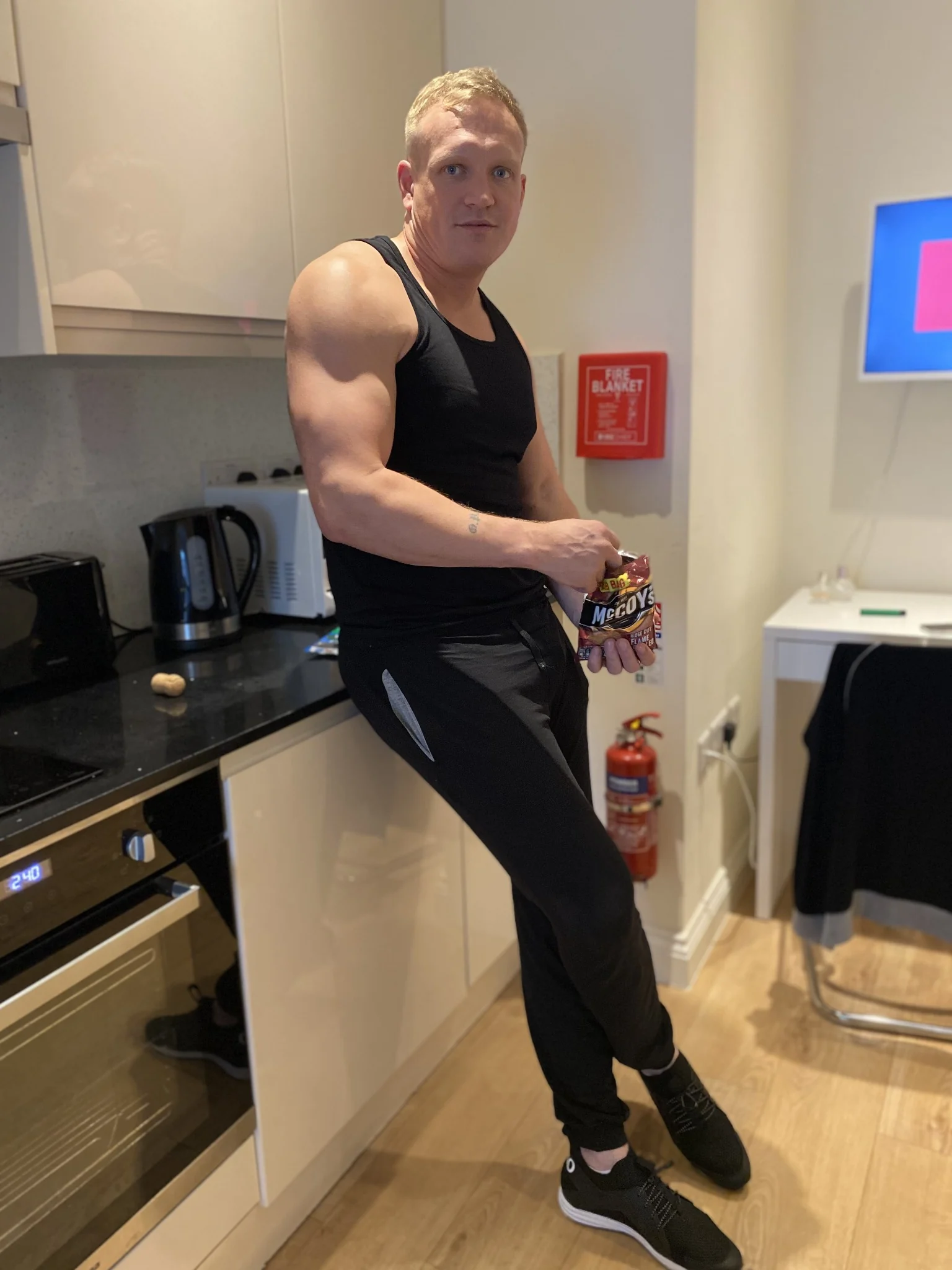 Barry enjoying a packet of crisps in his kitchen